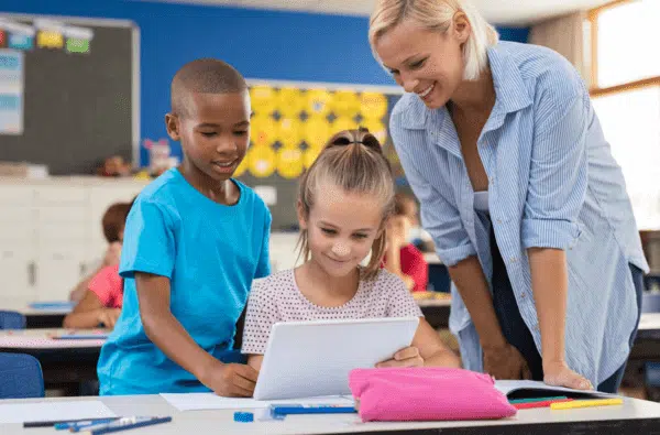 Teacher helping her students to study.