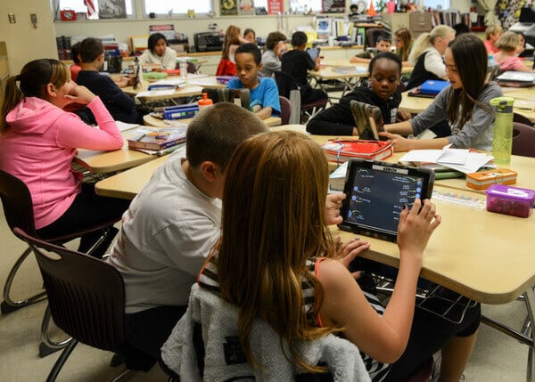 Students using ipads inside their classroom.