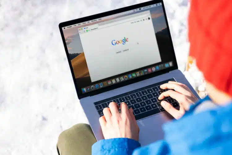 Student using her laptop to access google for homework.