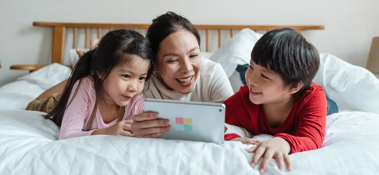 A mother teaching her children on how to be responsible digital citizens with the tablet