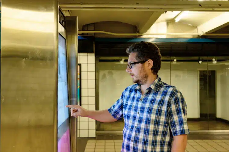 An employee using digital signage to check company's information.