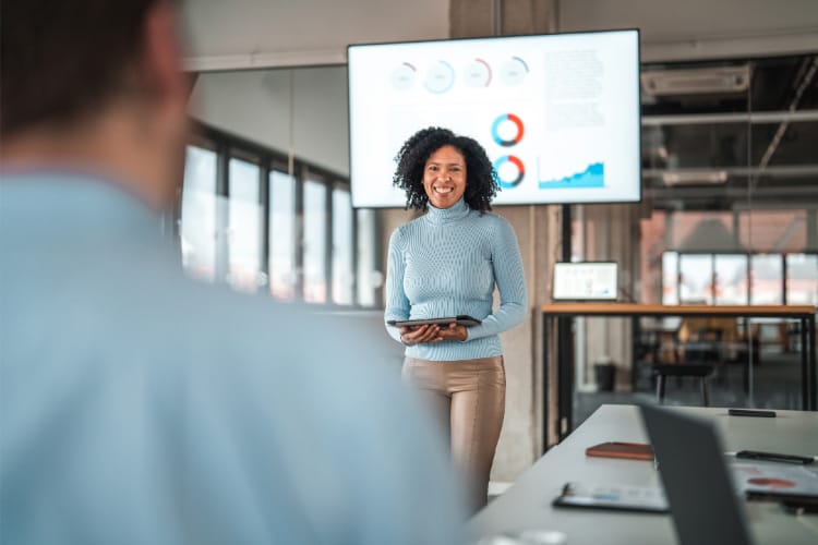 Female marketing discussing her content research about their digital signage project.