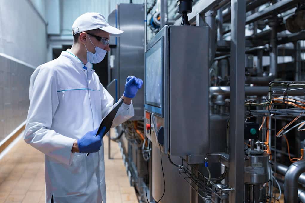 A manufacture employee checking the safety guidelines in the digital screen.