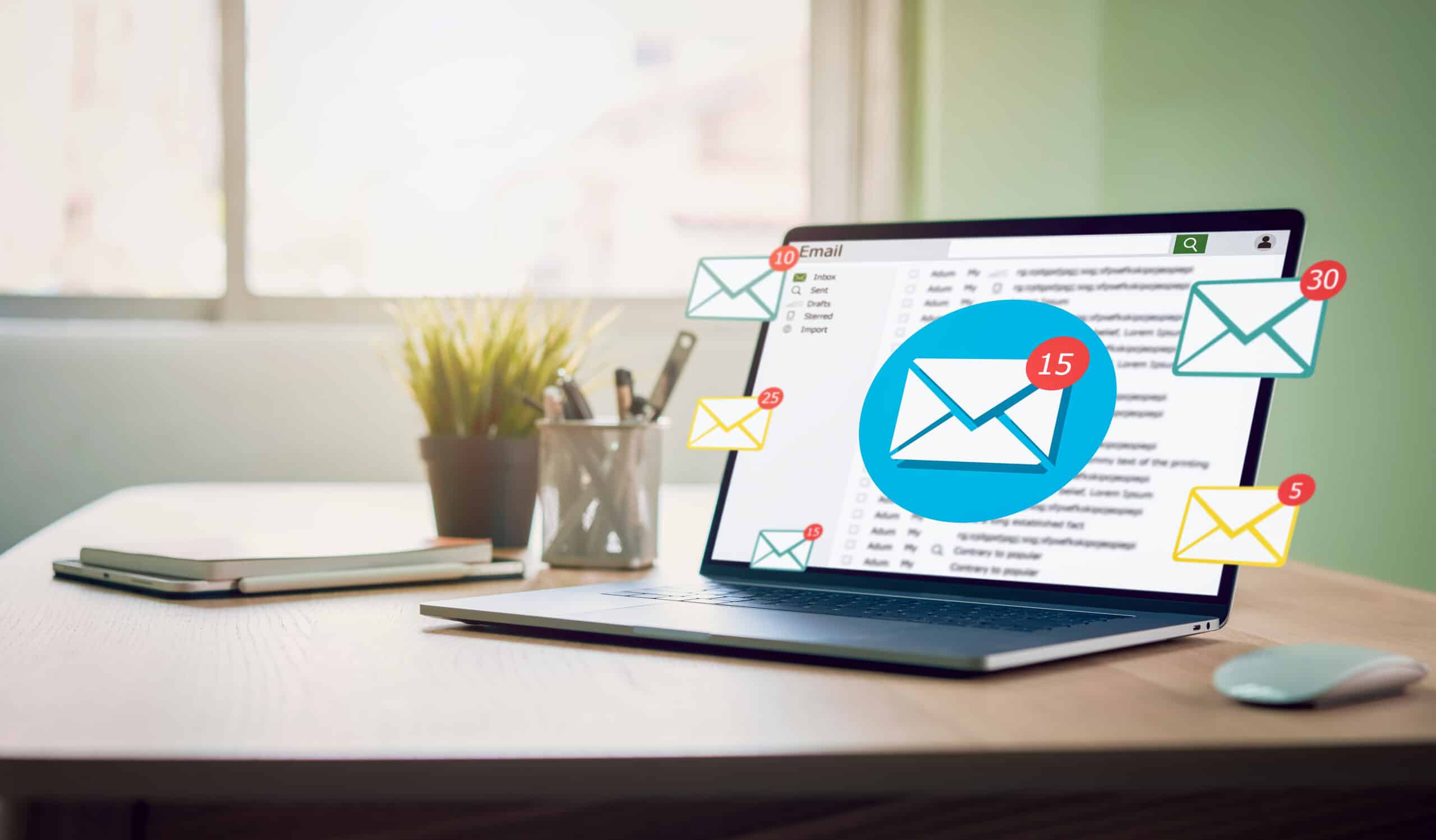 A laptop on a desk with Emails