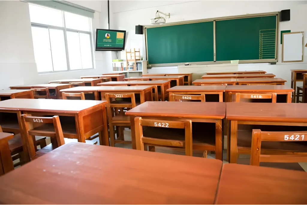 Empty classroom with a Digital signage screen beside the board.