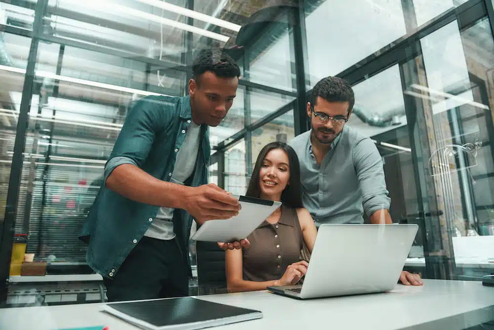 Team of young employees searching for digital signage solutions.