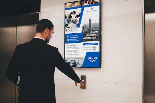 digital signage beside elevator in an office