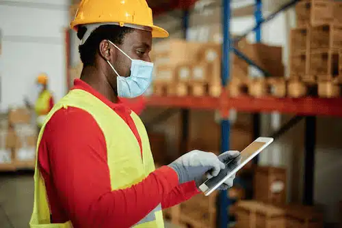 factory worker using digital signage for better factory workflow