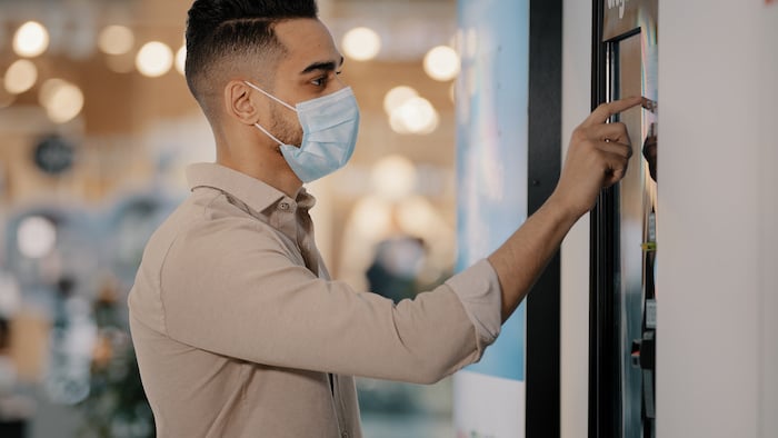 man touching screen of dynamic Digital Signage in Charlotte