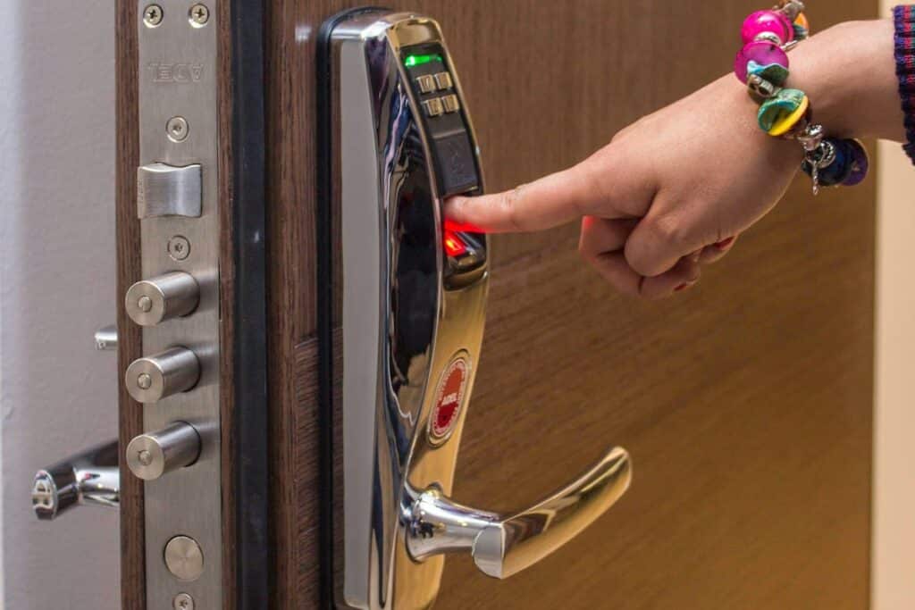 A Person Holding a Silver and Black Door Lever
